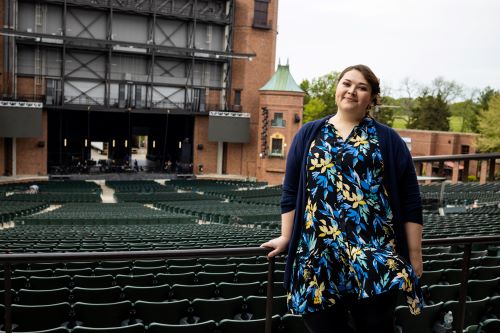 student stands in front of stage at Starlight Theatre