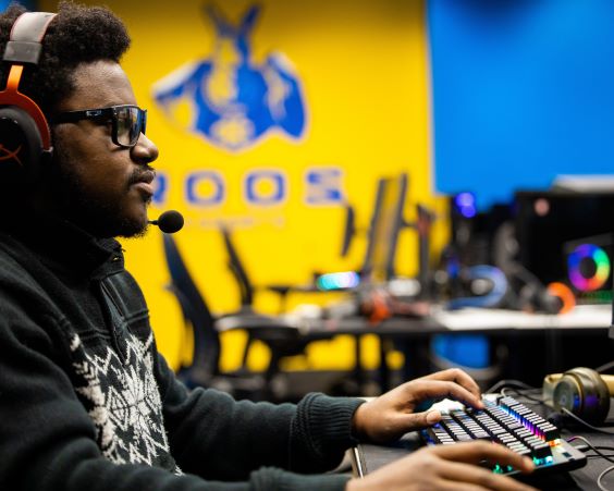 student plays at gaming system during esports competition