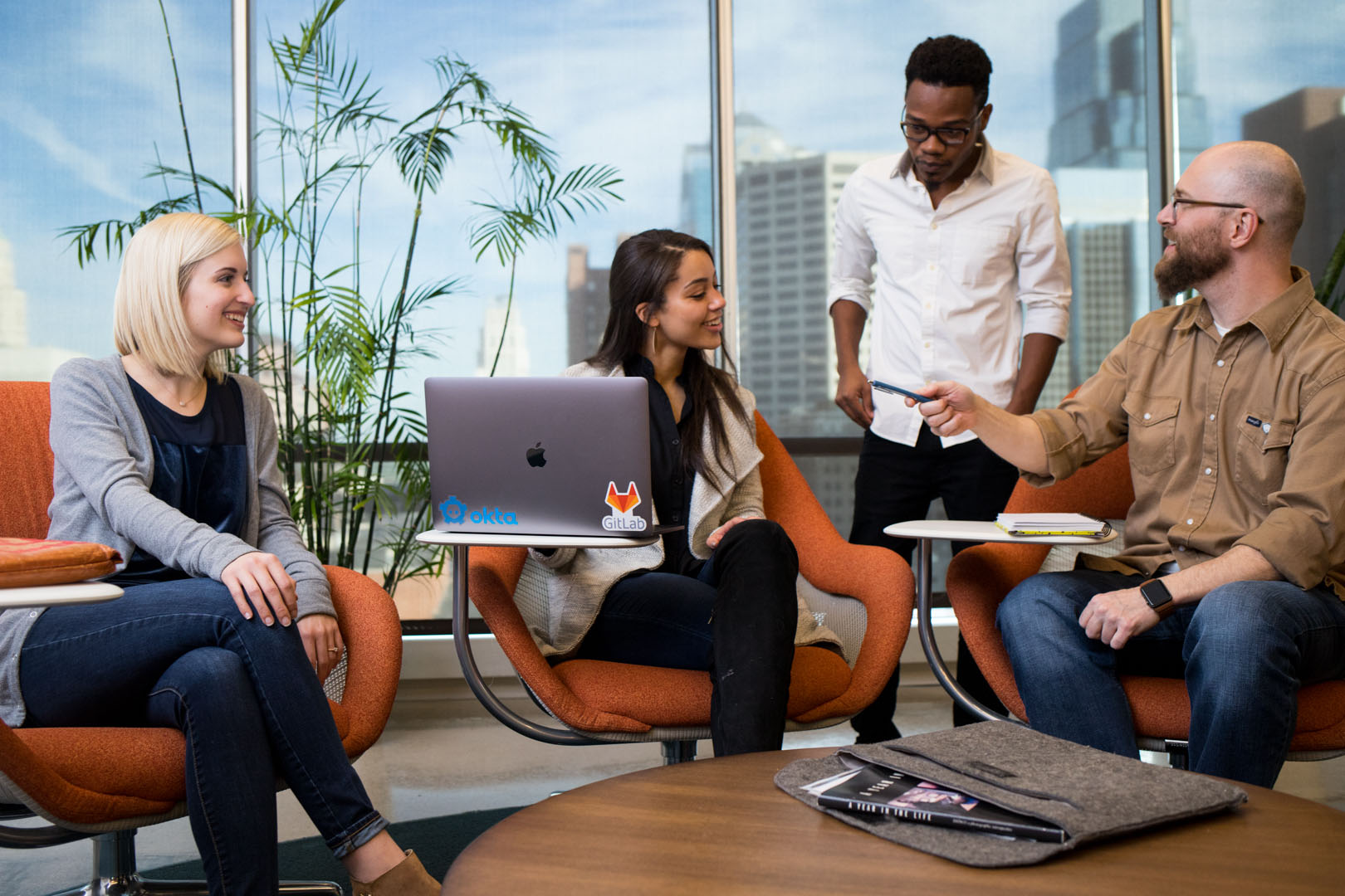 4 faculty members sitting around a coffee table chatting