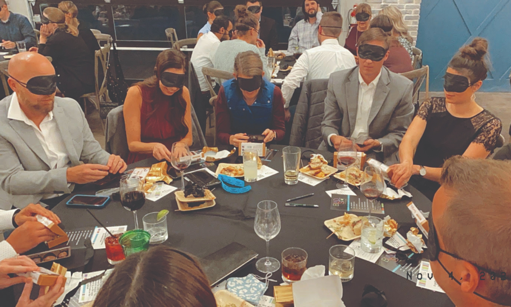 Image of dinner guests engaging in a blindness exercise.