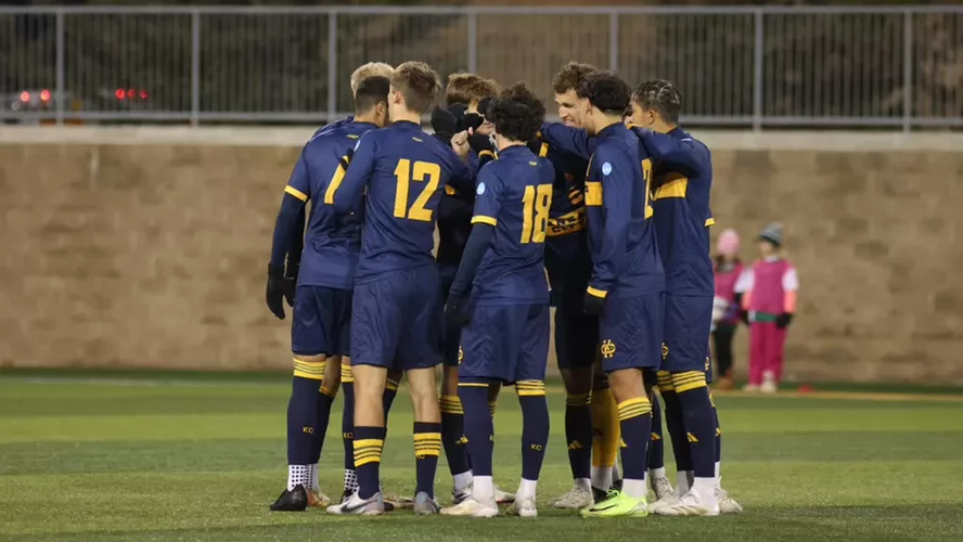 UMKC Roos men's soccer huddle together on the field after historic season