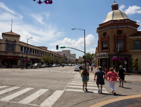 People walking across a crosswalk at Kansas City's Plaza shopping center.