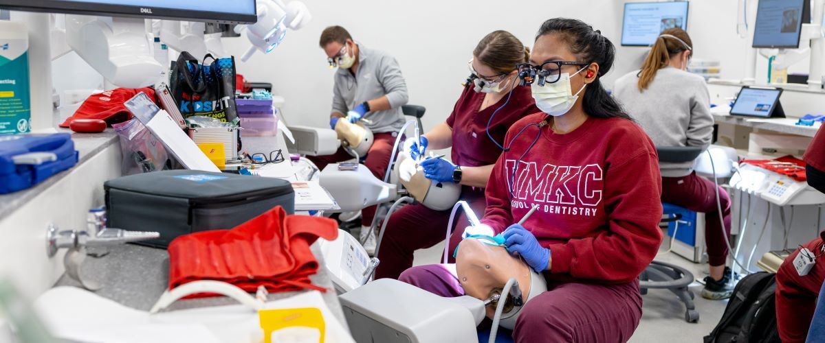 Dental students practice on models in the sim lab