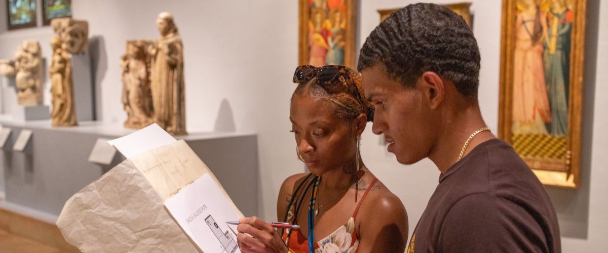 Two science and engineering students make notes while in the ancient art galleries of the Nelson Atkins Museum of Art