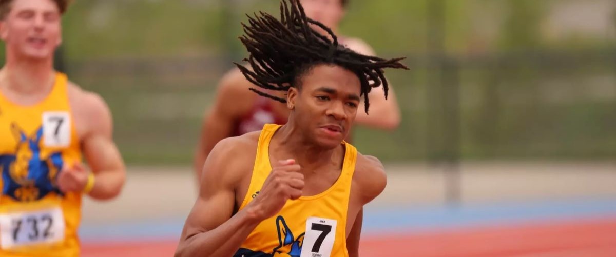 Member of UMKC relay team runs with baton