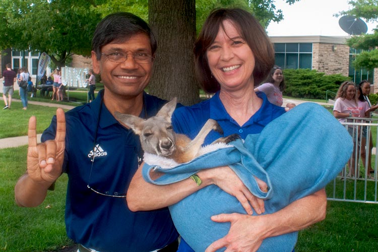 Chancellor Mauli Agrawal and his wife, Sue, holding a young kangaroo