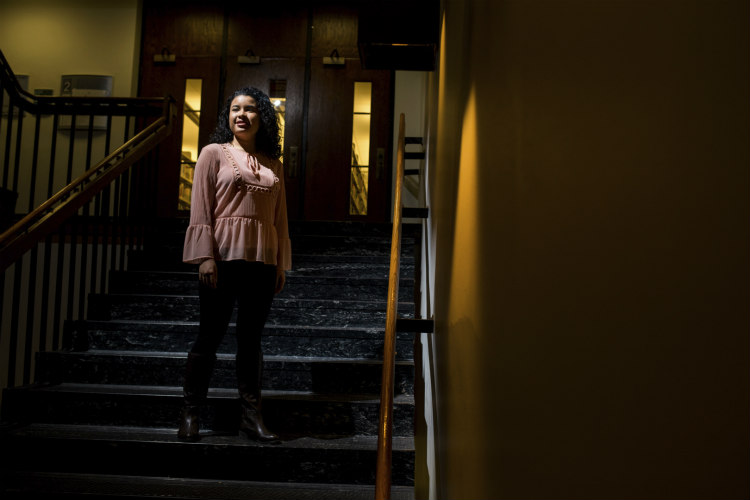 Dominique Paje, a female student at UMKC, stands in the stairwell.