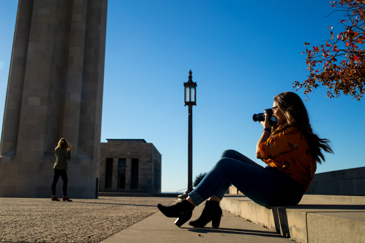 UMKC student Daphne Posadas takes photos outside Liberty Memorial