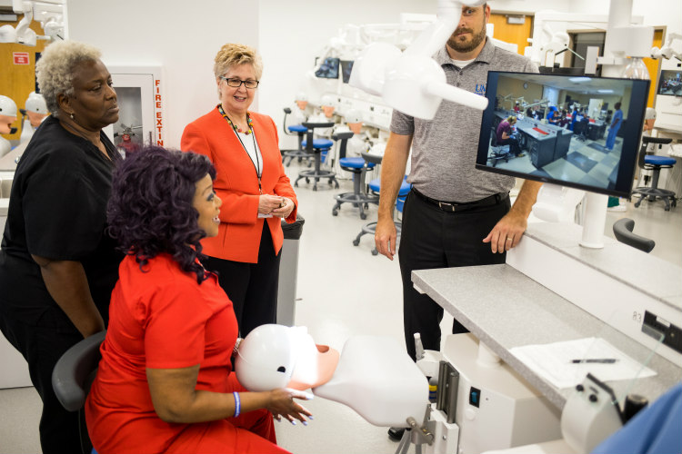 UMKC School of Dentistry Dean Marsha Pyle stands with other faculty and staff in new dental sim lab