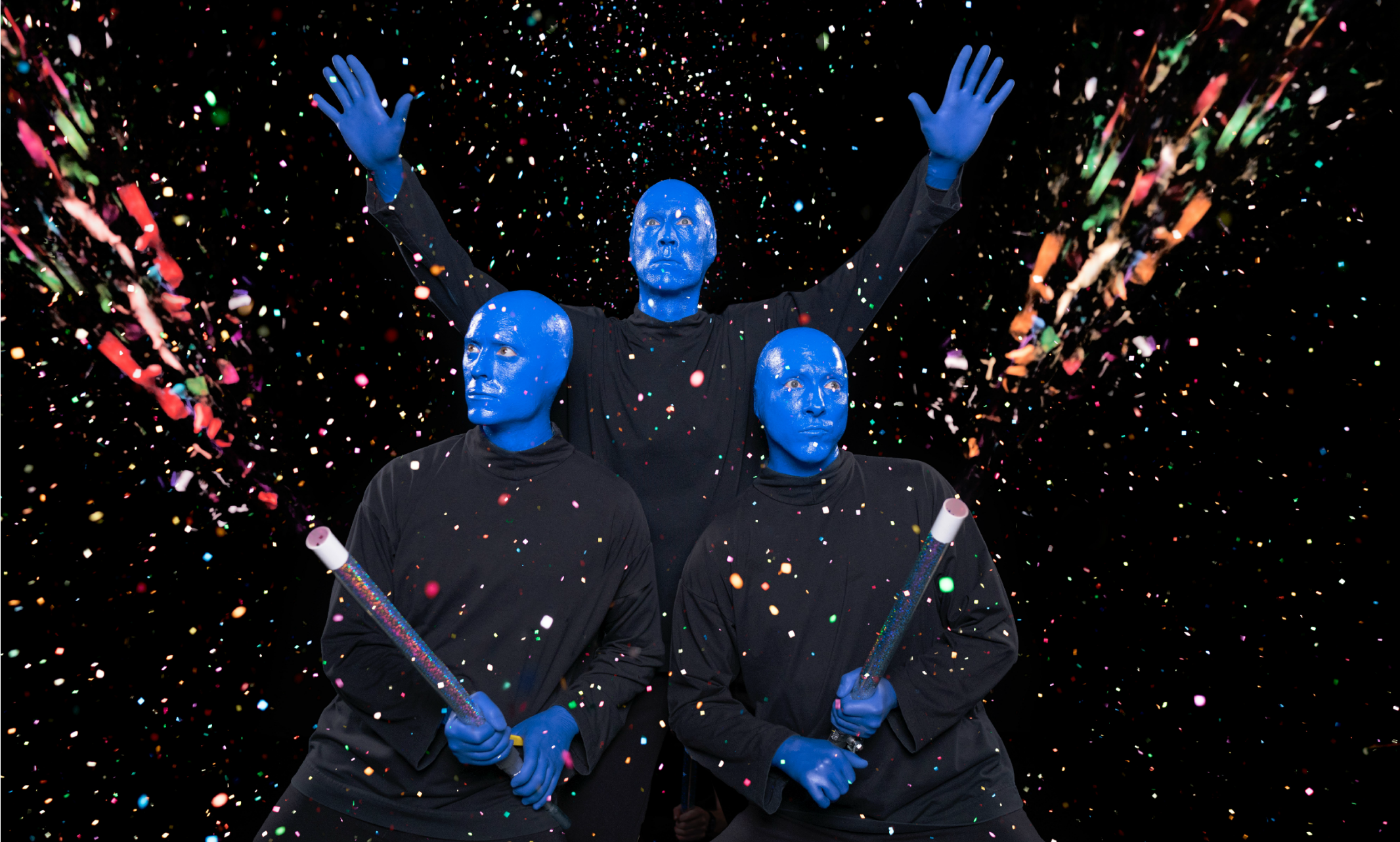 Matt Ramsey, pictured center, with the Blue Man Group spraying paint everywhere.