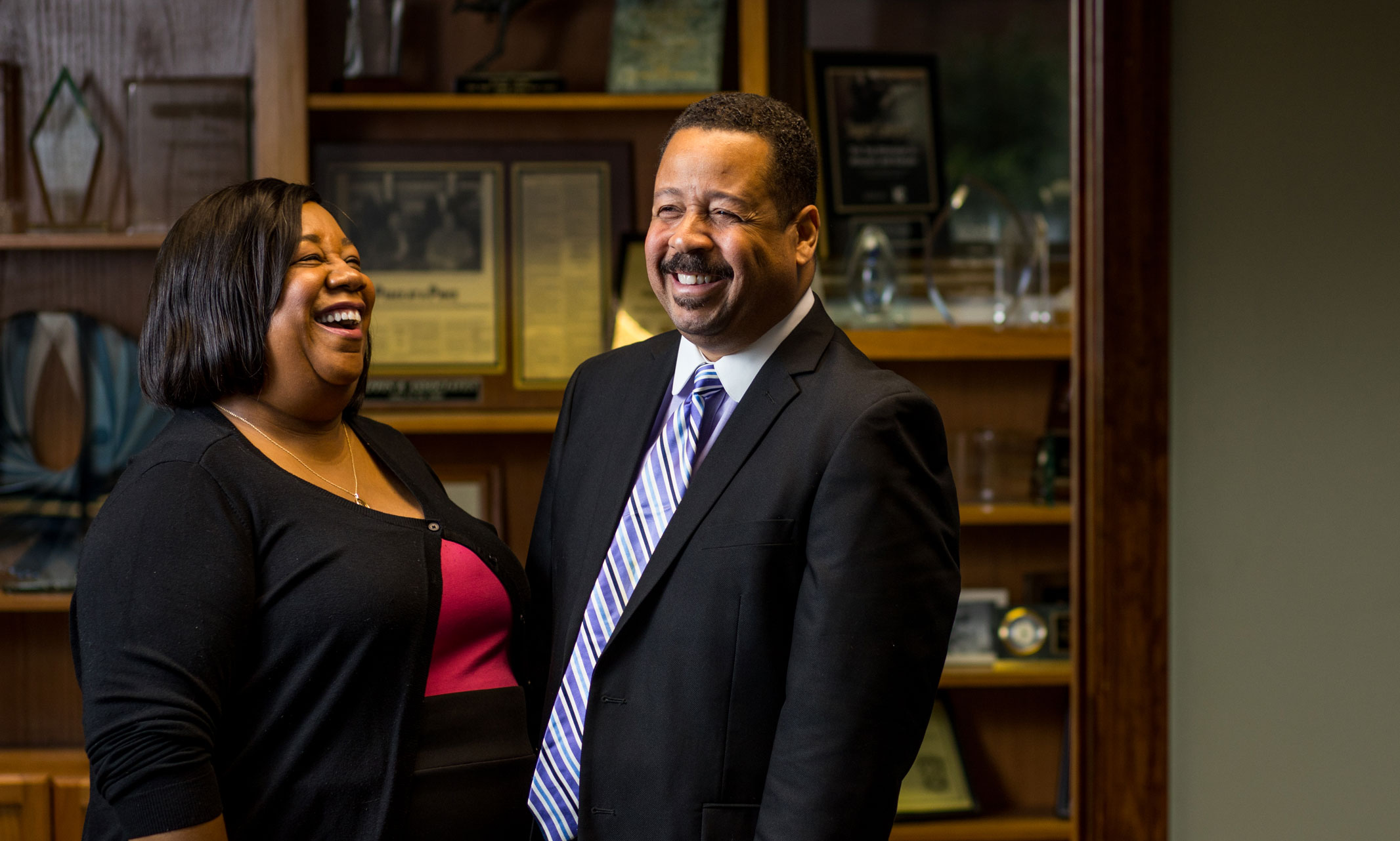Dana and Keith Cutler laugh together in their law office.