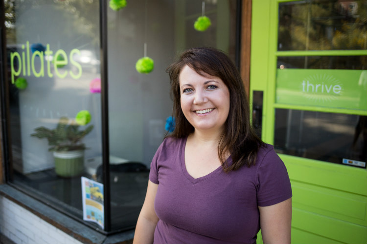 Lauren Thompson standing in front of her business, Thrive Pilates