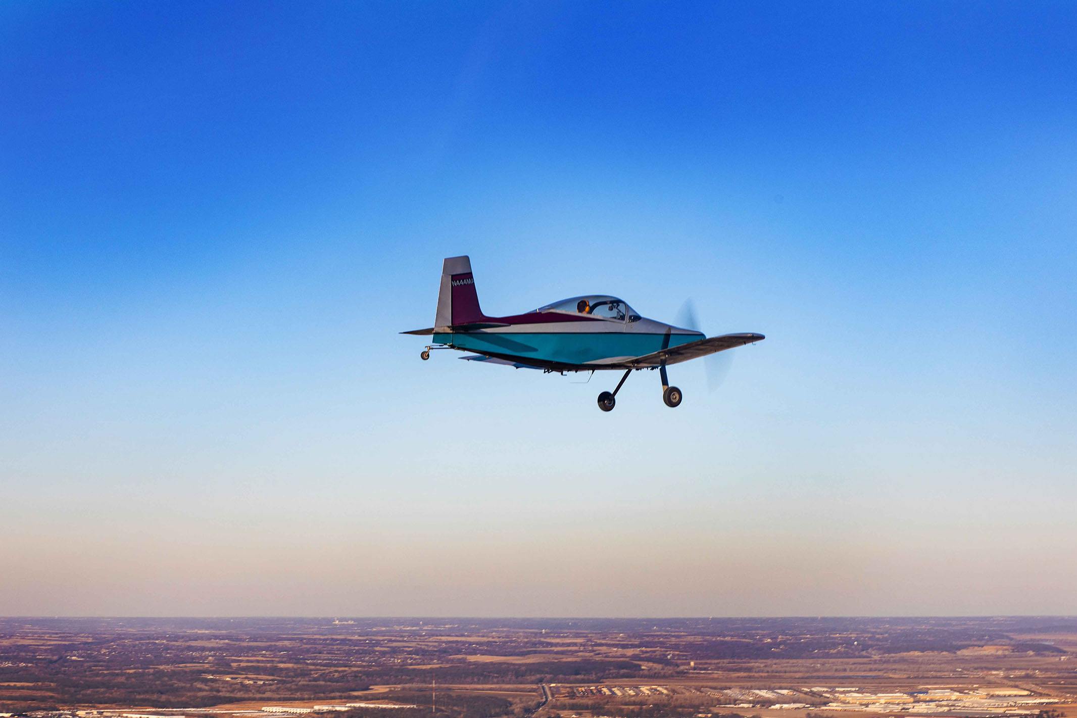 Faculty flies plane over the blue skies of Kansas City