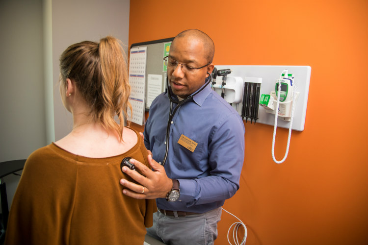 Obie Austin sees a student patient in the student health clinic