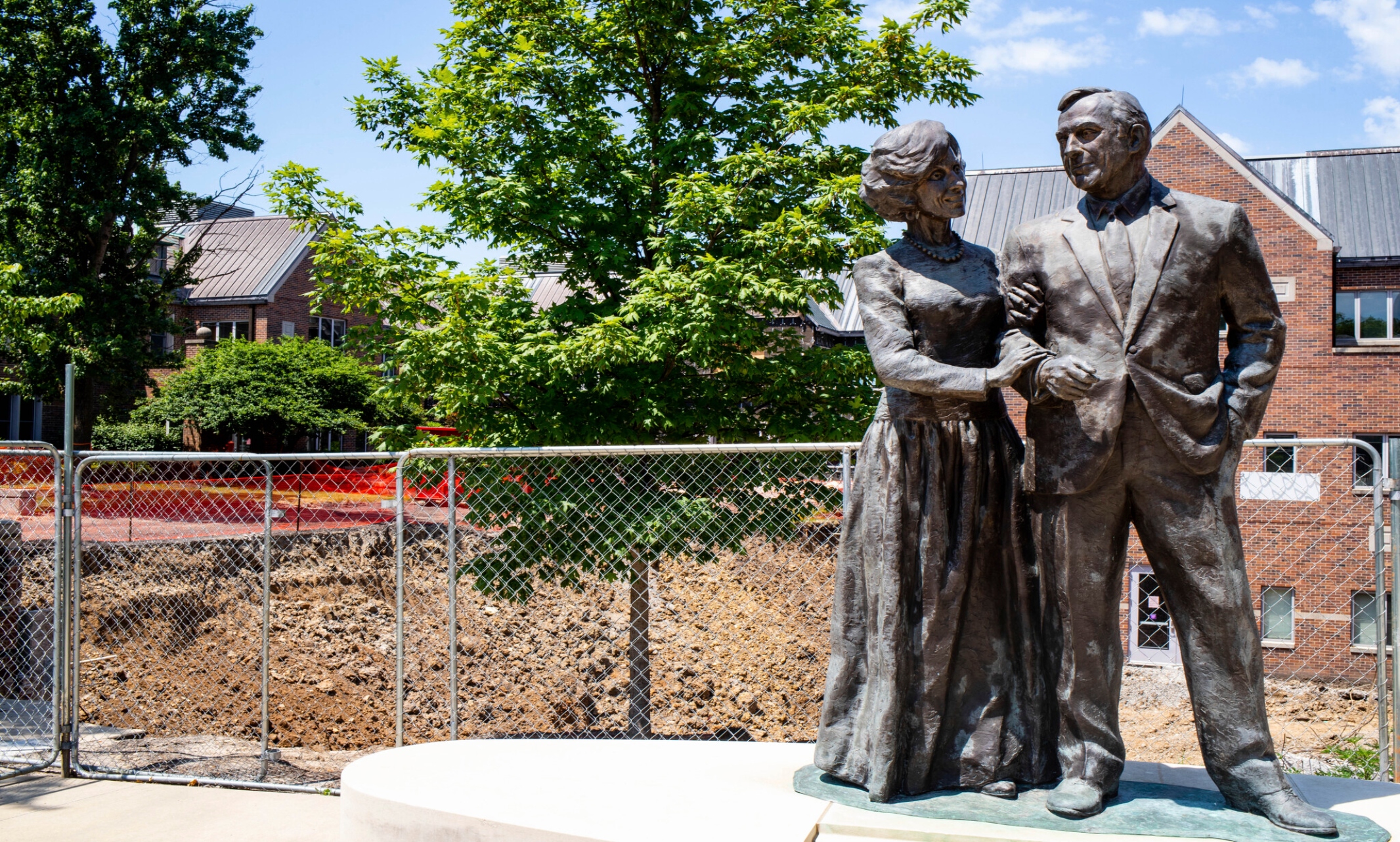 Statue of Henry and Marion Bloch in front of Bloch Heritage Hall construction site