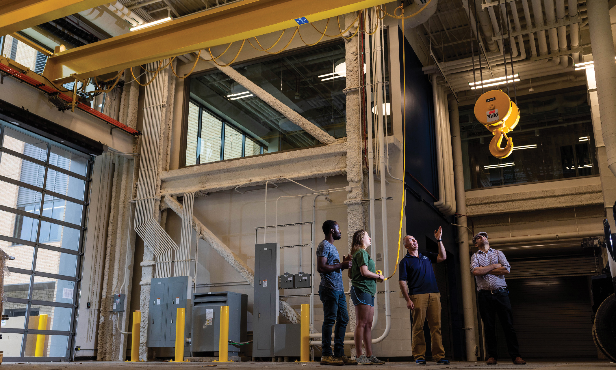 Professor John Kevern stands in the new structural lab space with students