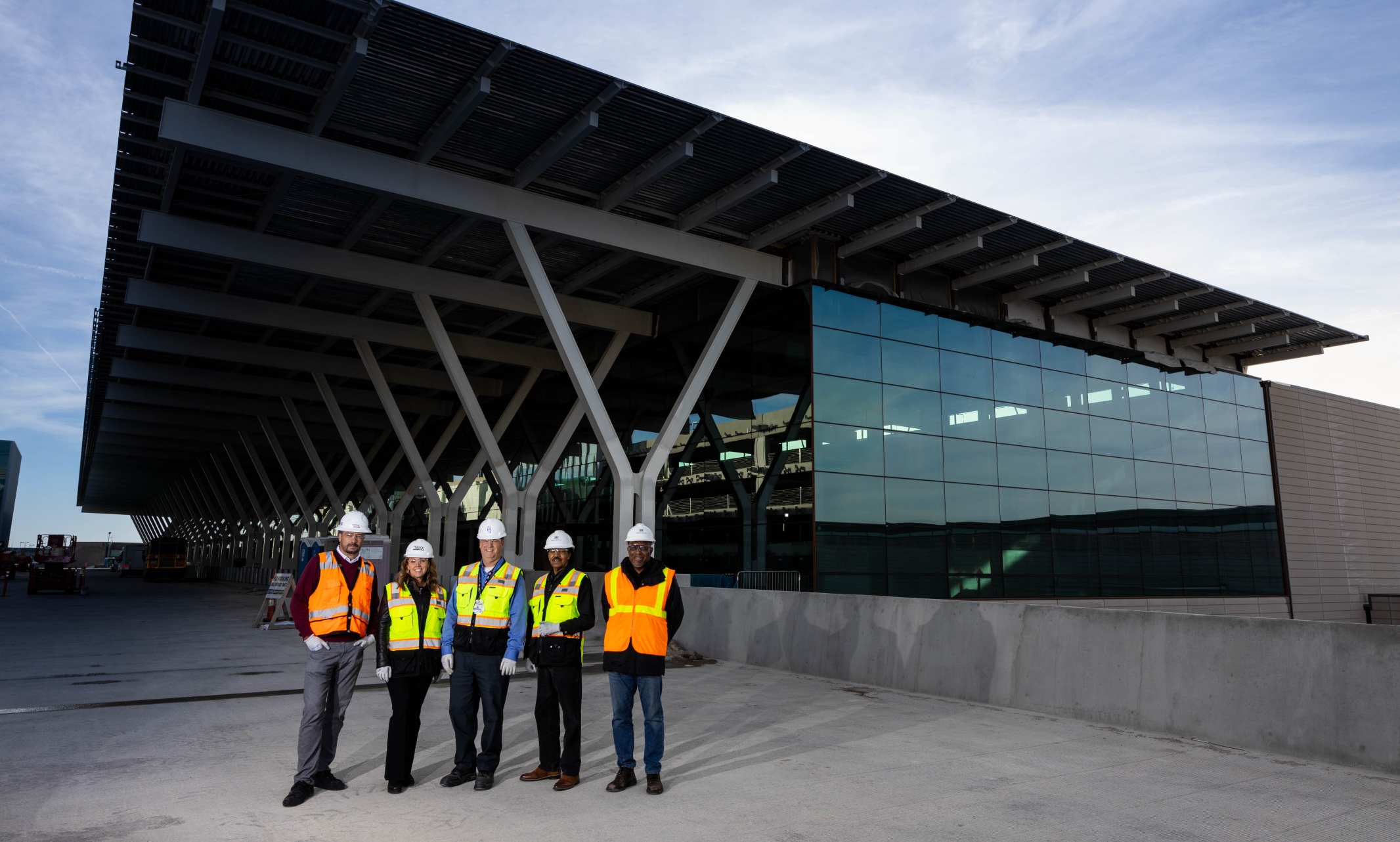 Alumni stand in front of the new KCI terminal 
