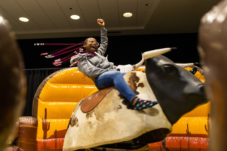 A student rides a bull at Late Night with the Greeks