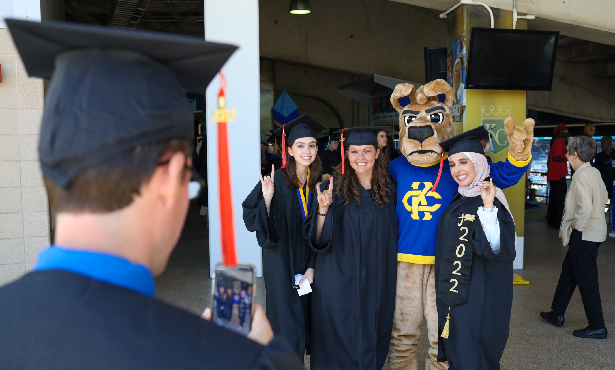 Graduates pose for photo with KC Roo