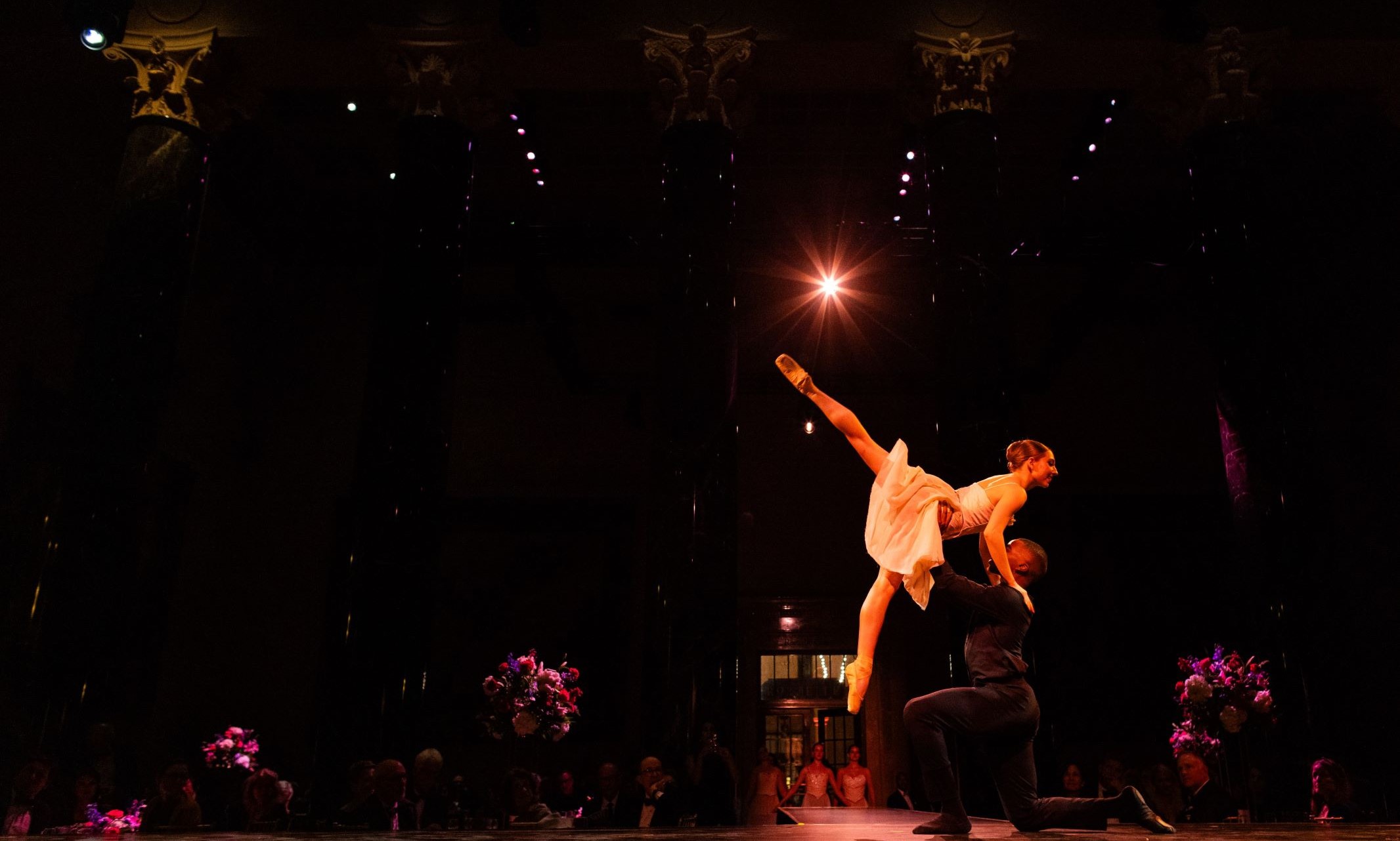 Two ballet dancers perform in an intimate setting.