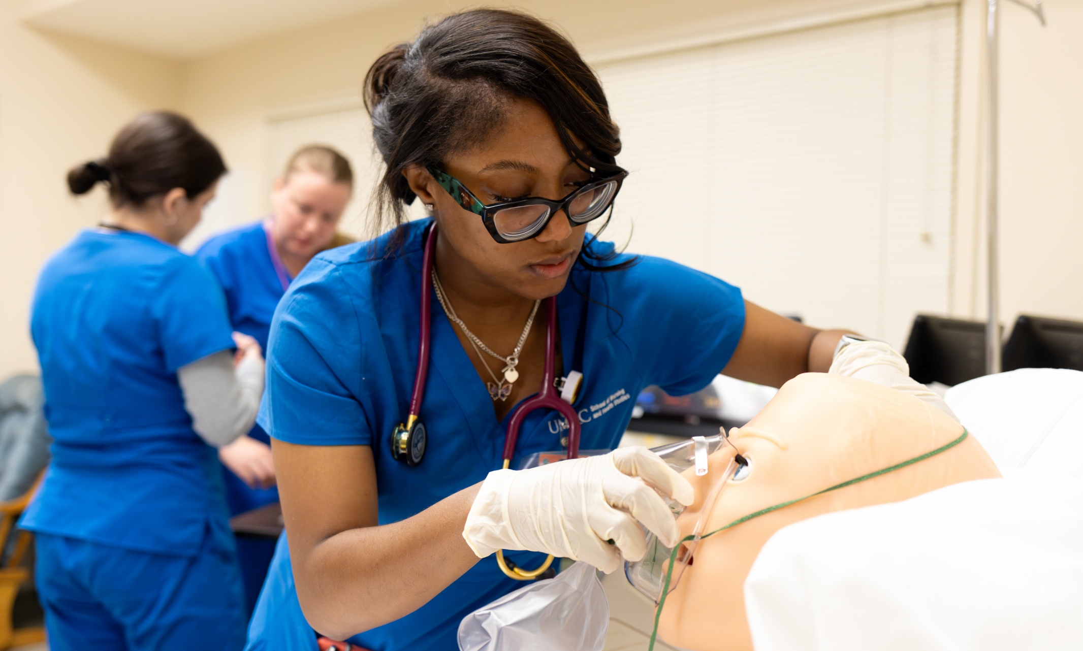 A nursing student works in a simulation lab.