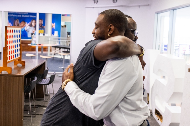 Aijalon and Roland hug inside the MSA student space