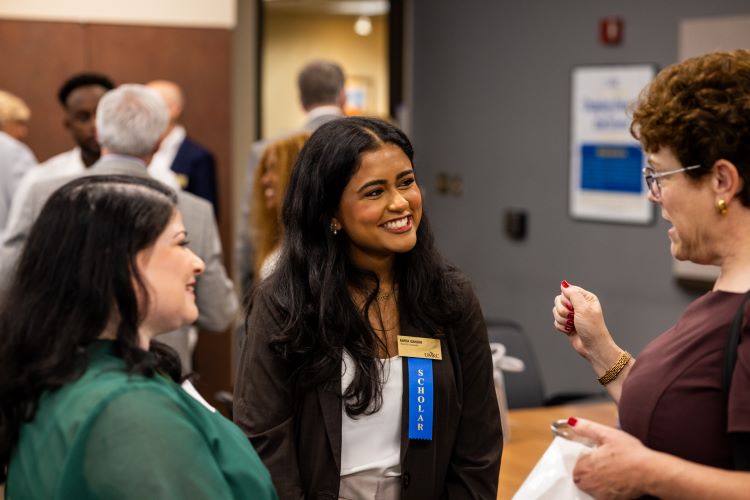 UMKC new trustees' scholar smiling as she listens to what people have to say