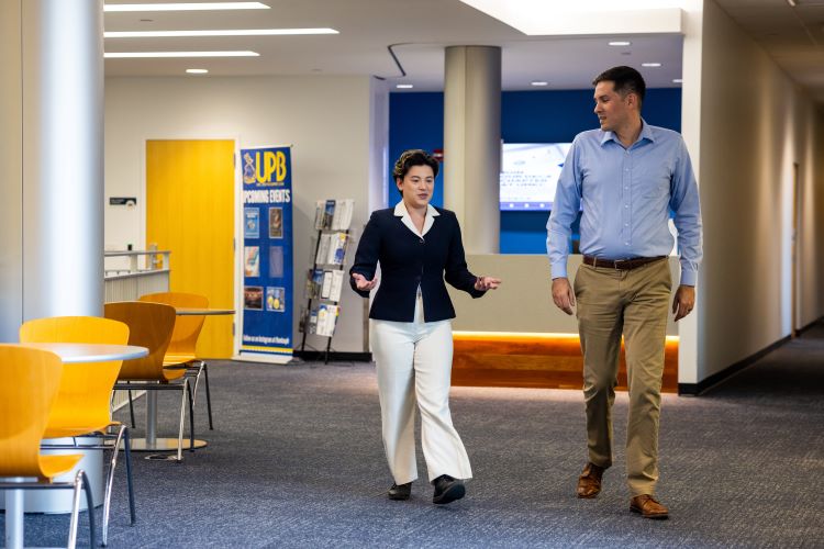 Daniel Maitland and Jennifer Truitt walking together in student union