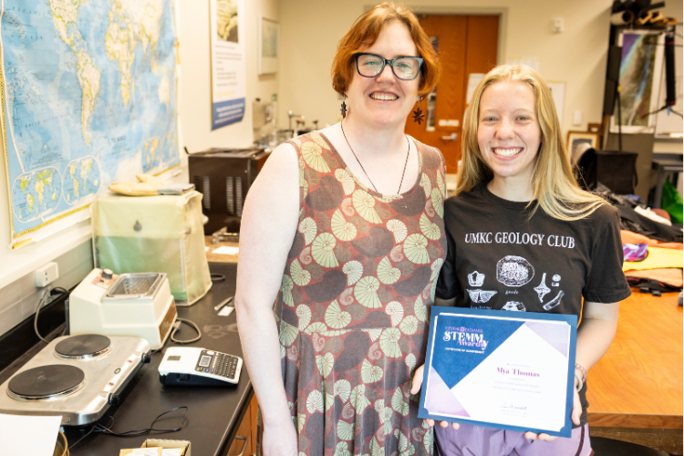 Mya Thomas poses with a professor as she holds the Central Exchange Student Achiever STEMMy Award. 