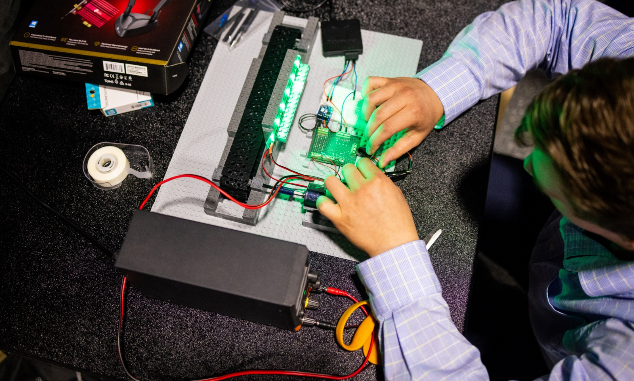 A person works on the inside component of a a computer