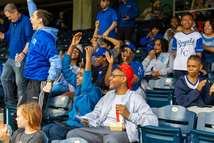 Students cheering from the stands at the Kauffman Stadium.