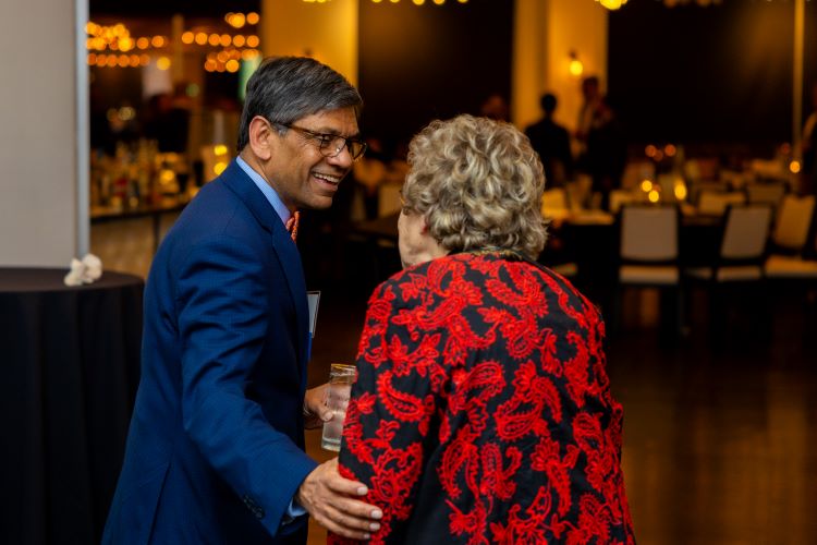 umkc chancellor mauli agrawal chatting with an older woman who is an gaf donor