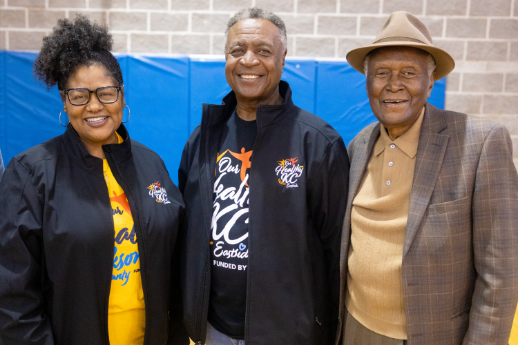 Alvin Brooks taking a photo with Jannette Berkley-Patton and Frank White smiling into the camera 