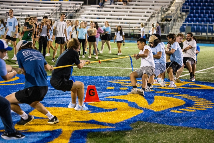 Two groups of greek life students play tug of war at Durwood