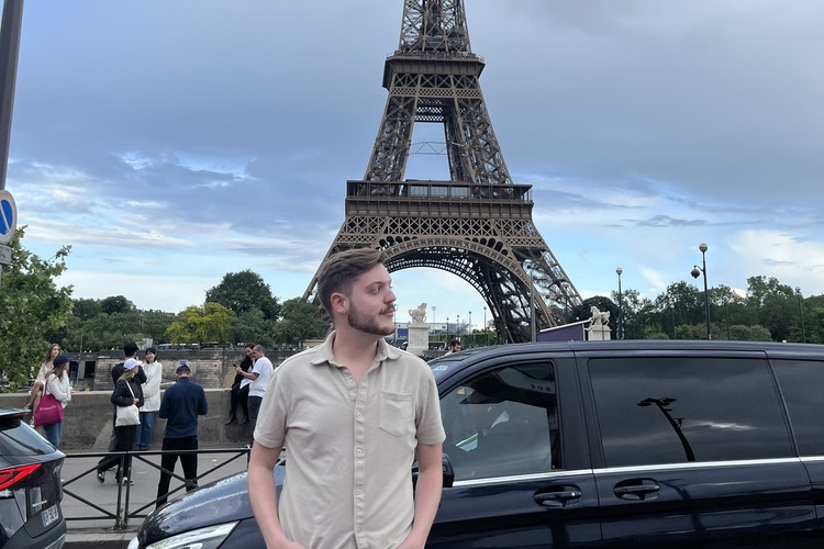 Hunter stands in front of the Eiffel Tower