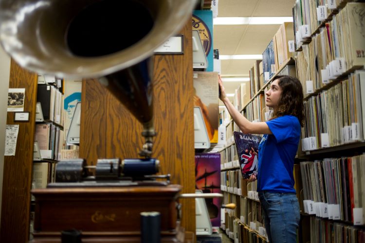 Part of the Marr Sound Archives, featuring a record player and student browsing the archives