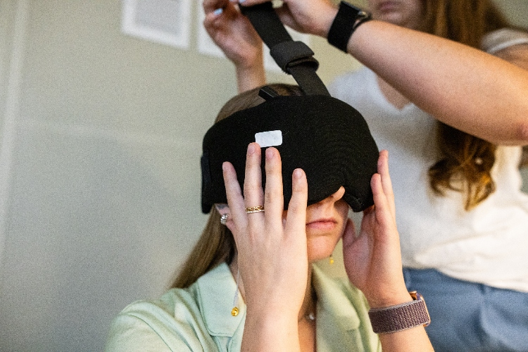 A student puts on a sleep mask.