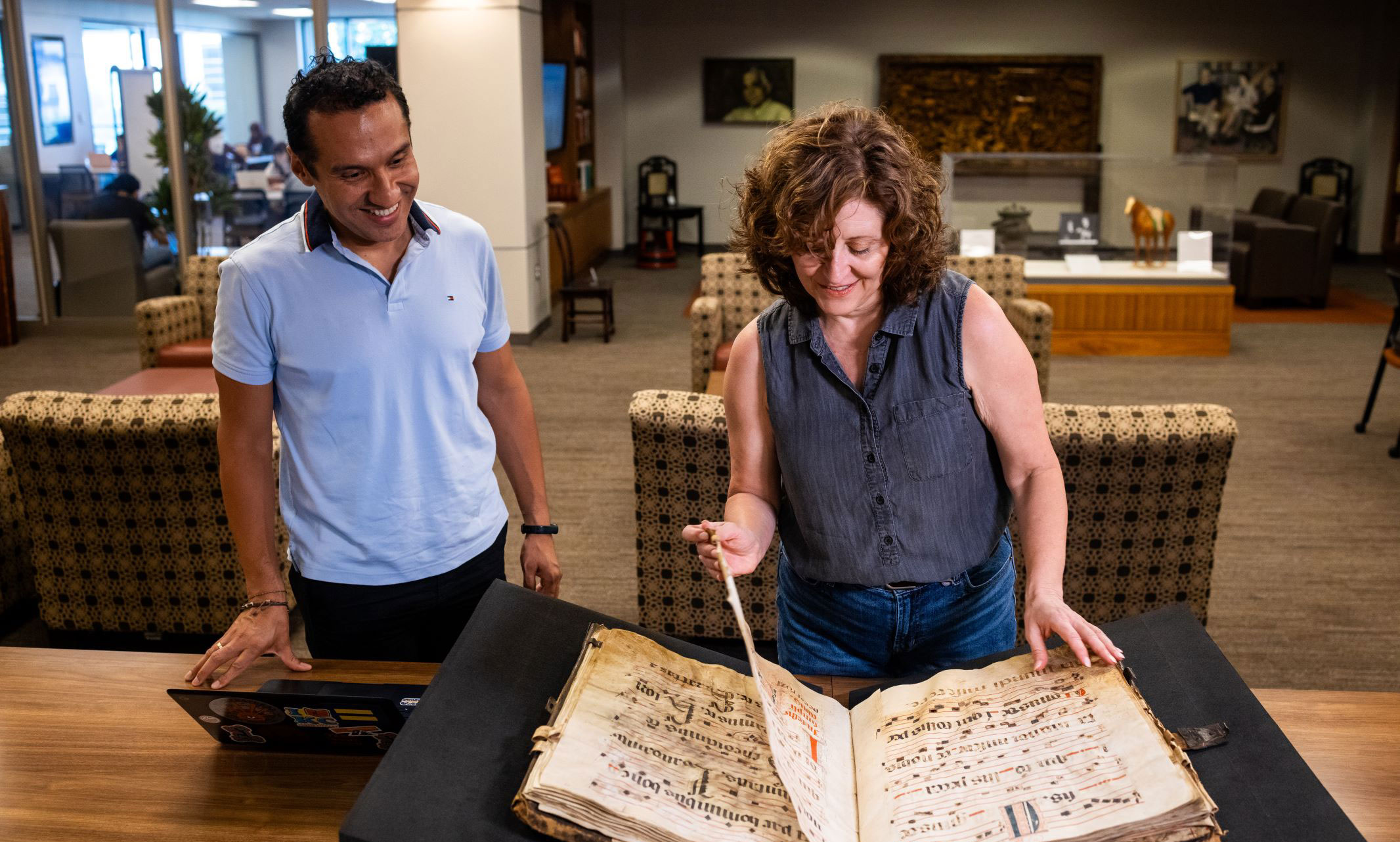 Virginia Blanton and Milton Gómez-Toledo looking at a text