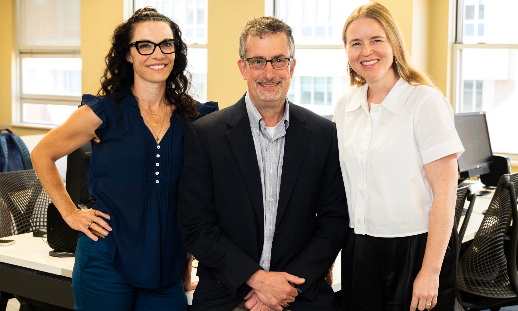 Three UMKC School of Medicine physicians stand in hospital library