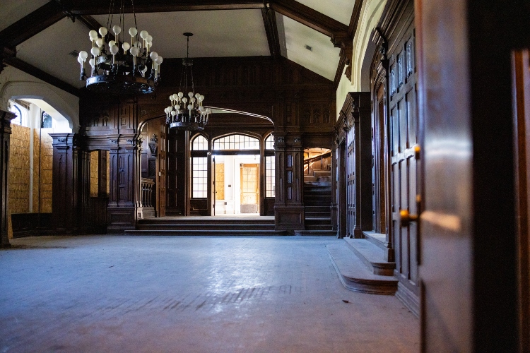 The ballroom in Epperson House, a large, multi-story room with high ceilings, chandeliers and woodwork