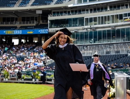 Student celebrates graduation on field at Kauffman Stadium