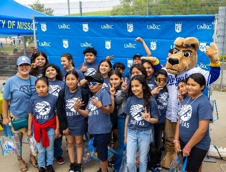 KC Roo poses with students at School Day at the K