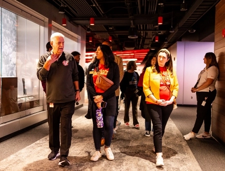 UMKC students walk down a hallway in Arrowhead stadium as they listen to a Chiefs historian on a tour of the stadium.