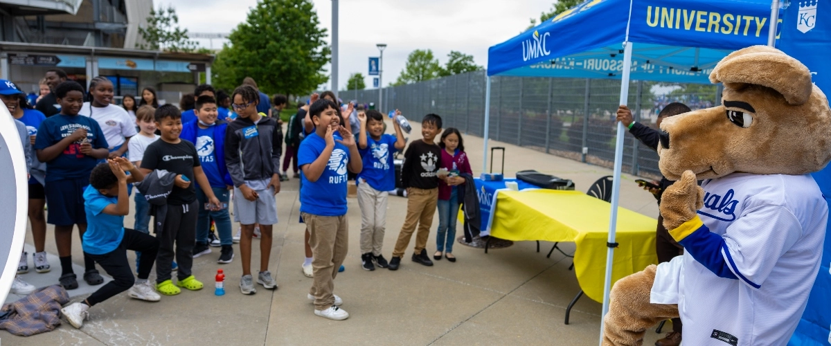 Children interact with KC Roo at School Day at the K