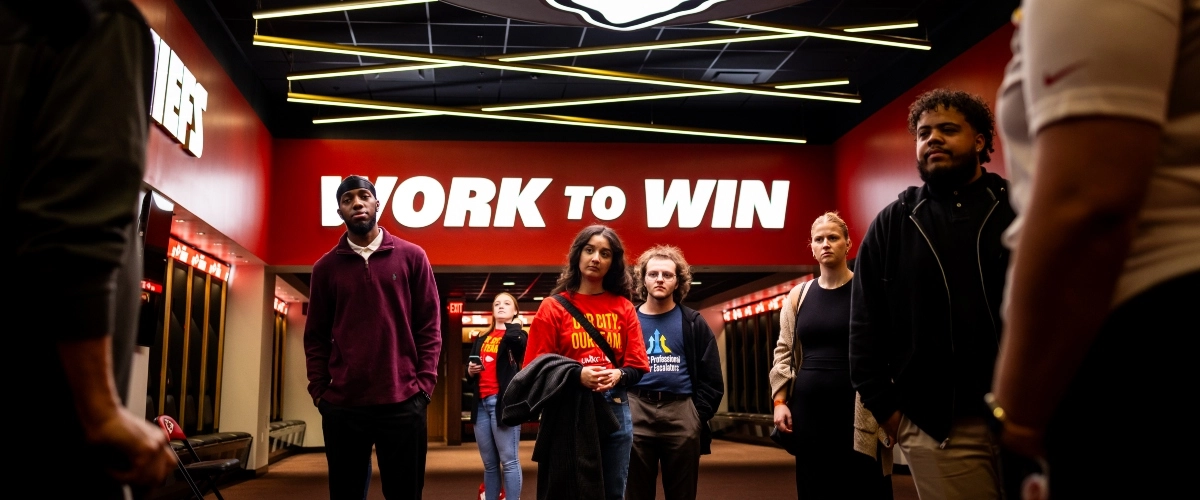 UMKC students tour the Chiefs locker room while on a tour with a Chiefs team historian.