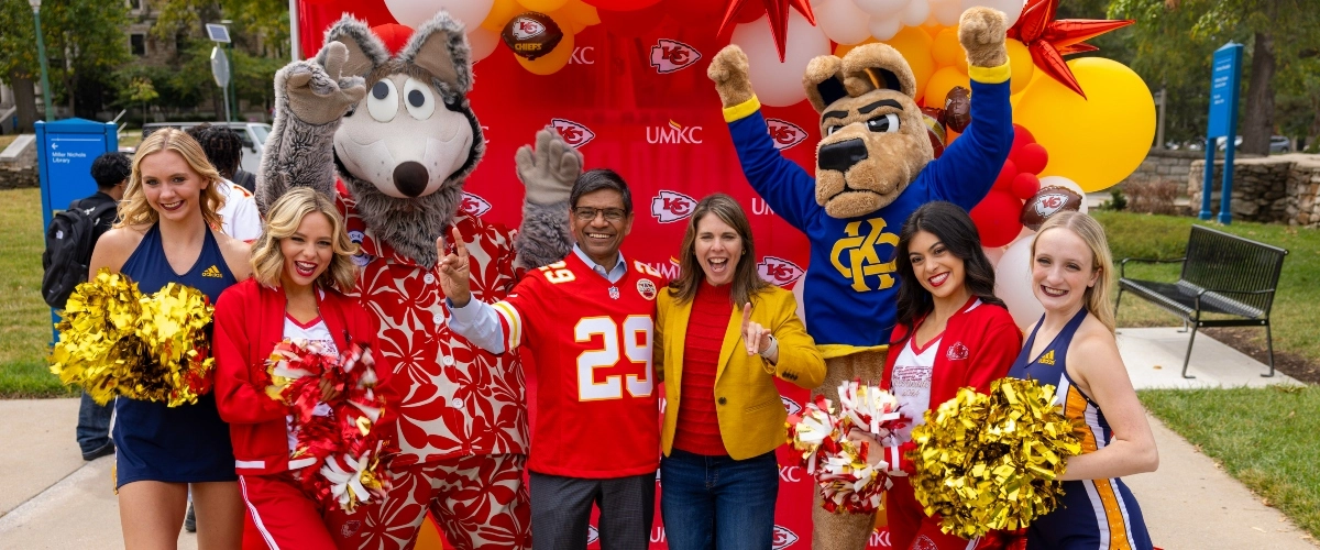 UMKC's chancellor and provost pose with KC wolf, KC Roo and members of the Chiefs and UMKC cheer teams at the annual Red Friday Roos Tailgate.