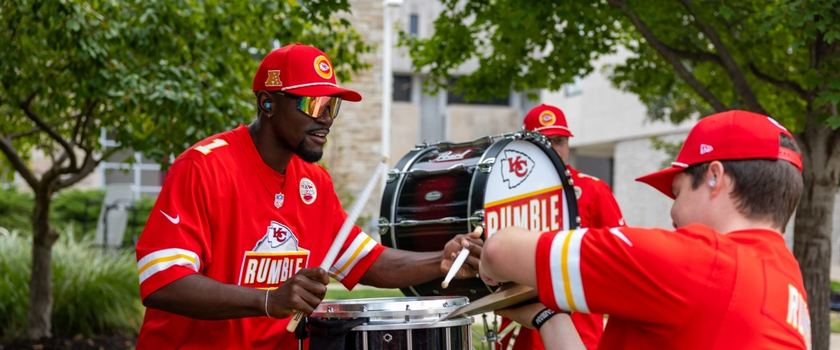 Members of Rumble and Mob playing their drums and symbols at the annual Red Friday Roos Tailgate.