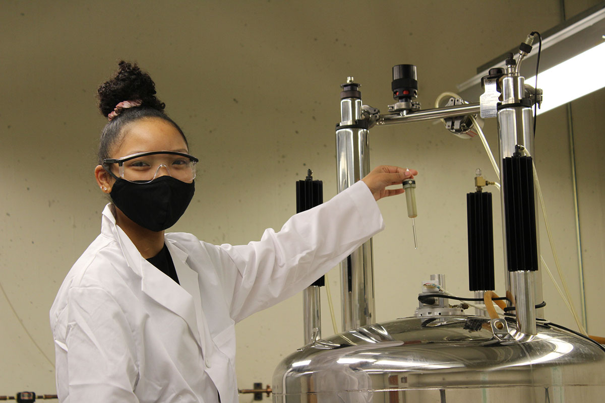student operates lab equipment